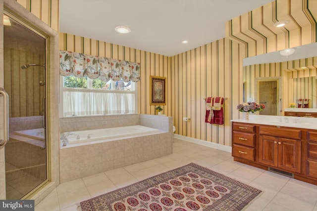 bathroom featuring vanity, independent shower and bath, and tile patterned flooring