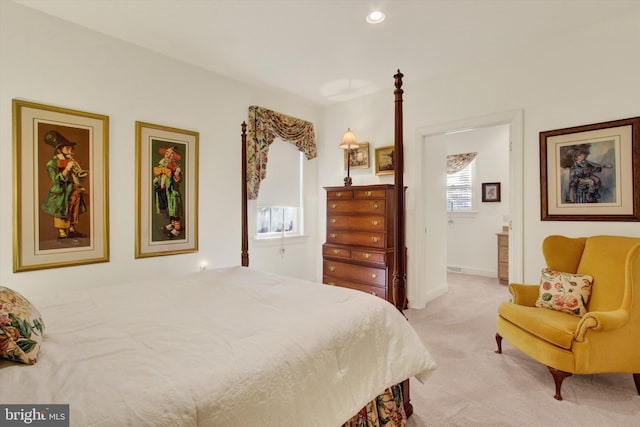 carpeted bedroom featuring ensuite bath