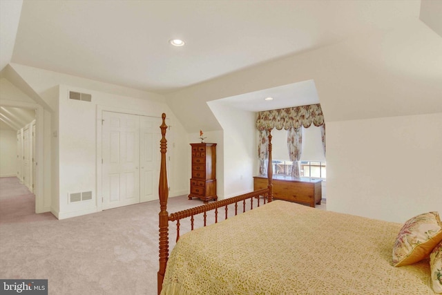 carpeted bedroom featuring a closet and lofted ceiling