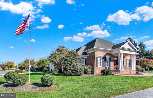 view of front of property with covered porch and a front yard