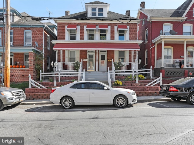 townhome / multi-family property featuring covered porch