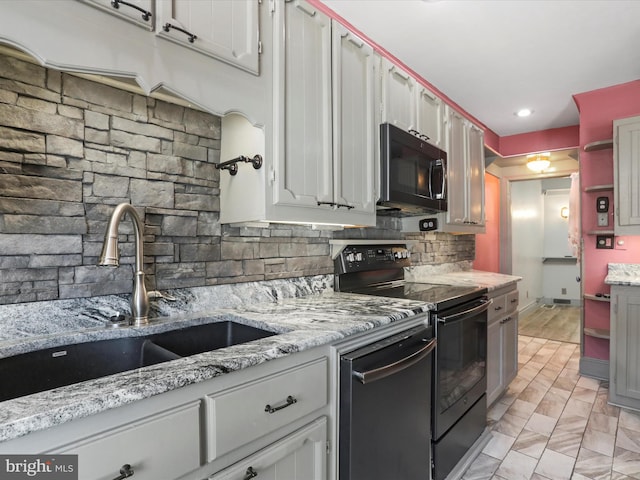 kitchen featuring backsplash, sink, appliances with stainless steel finishes, and white cabinets