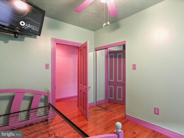 interior space with wood-type flooring and a textured ceiling