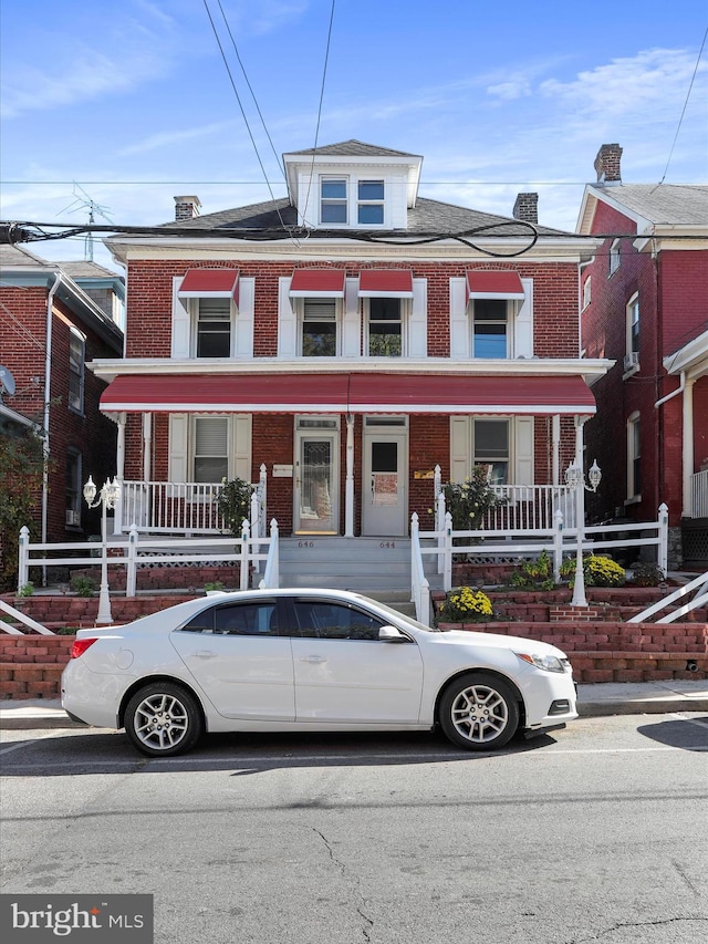 townhome / multi-family property featuring a porch