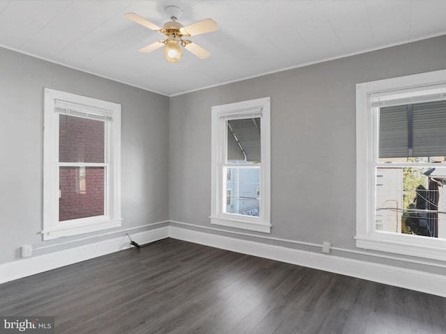 unfurnished room featuring ornamental molding, ceiling fan, and dark hardwood / wood-style flooring