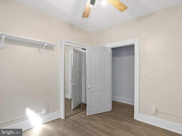 unfurnished bedroom featuring a closet, wood-type flooring, and ceiling fan