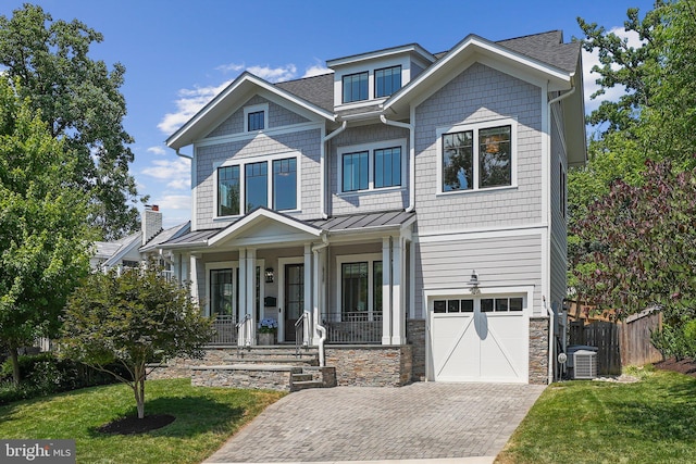 craftsman inspired home featuring central AC, a front yard, a garage, and a porch