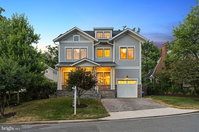 craftsman house featuring a yard and a garage