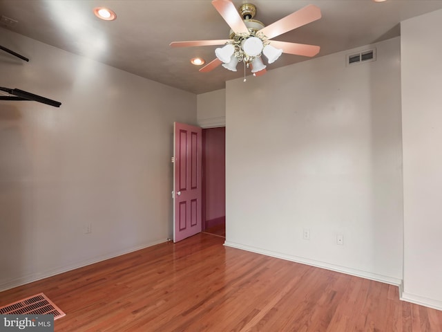 spare room featuring light wood-type flooring and ceiling fan