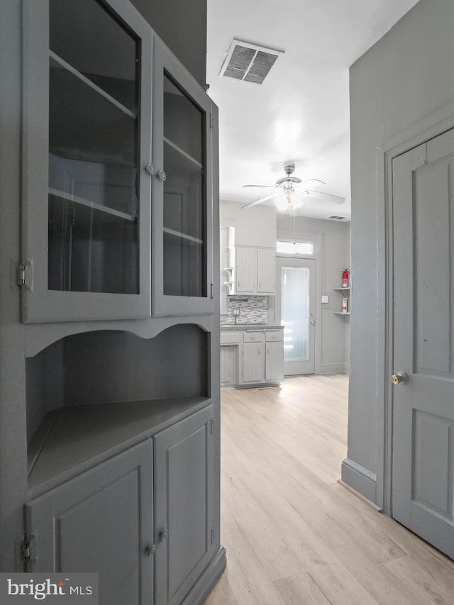 corridor with light hardwood / wood-style flooring