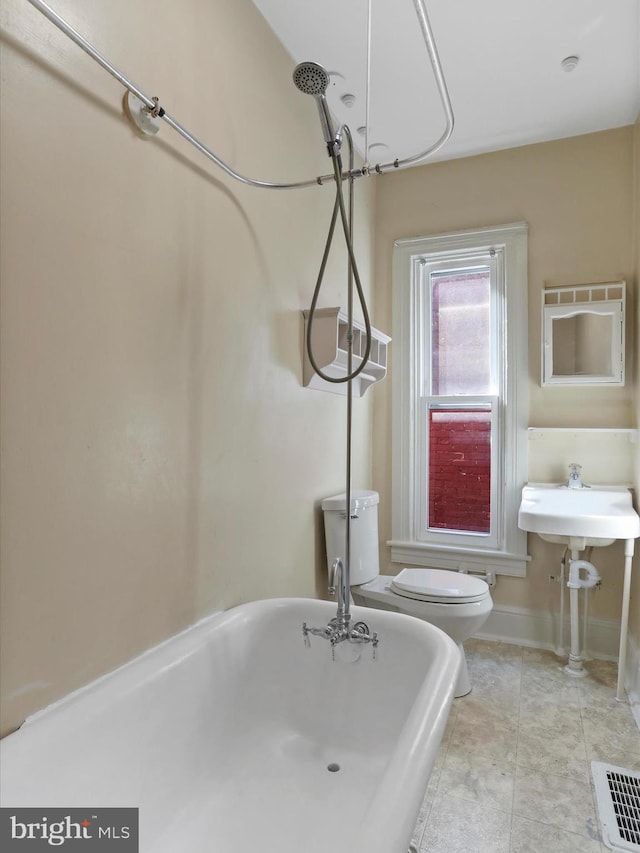 bathroom featuring toilet, independent shower and bath, and tile patterned floors