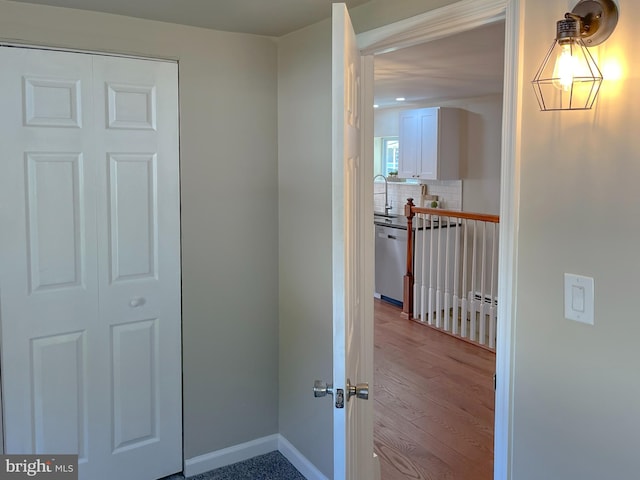 hallway featuring light hardwood / wood-style floors and sink