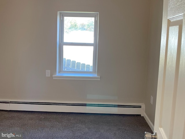 unfurnished room featuring a wealth of natural light, a baseboard radiator, and carpet flooring