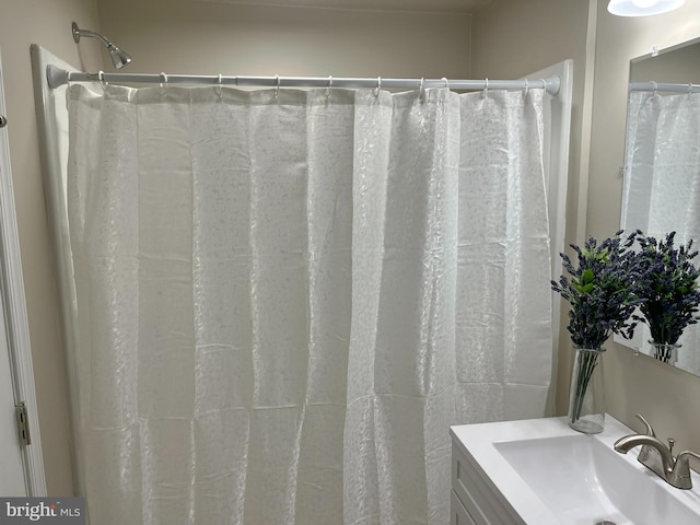 bathroom featuring vanity and curtained shower