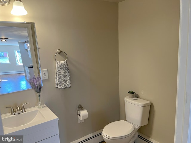 bathroom featuring vanity, toilet, and baseboard heating