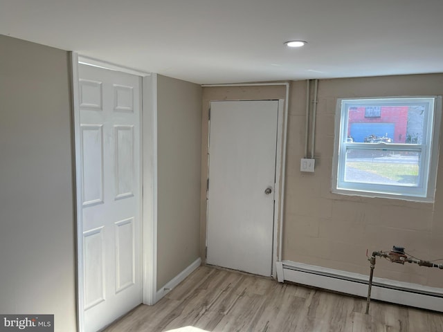 interior space featuring light hardwood / wood-style floors and baseboard heating