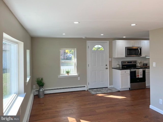 interior space with baseboard heating and dark hardwood / wood-style flooring