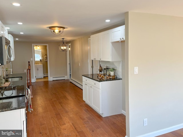 kitchen with sink, white cabinetry, and light wood-type flooring