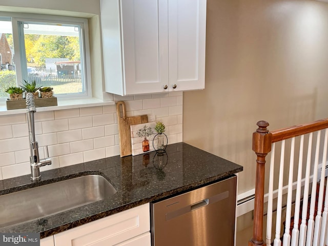 kitchen featuring sink, dark stone countertops, white cabinetry, and dishwasher