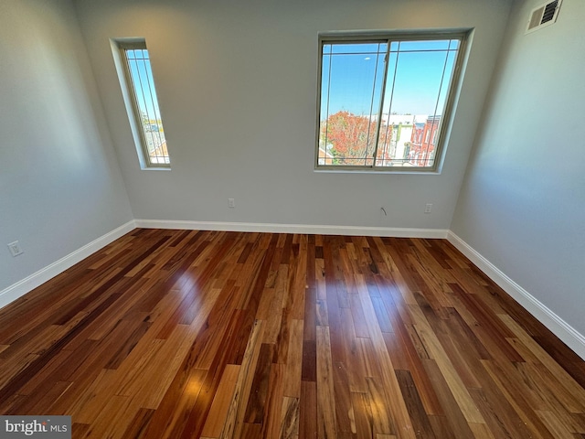 unfurnished room featuring dark hardwood / wood-style flooring