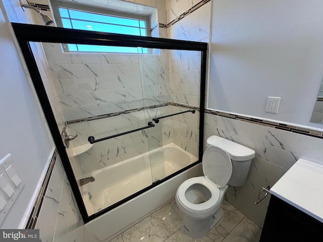 full bathroom featuring tile walls, vanity, enclosed tub / shower combo, and toilet