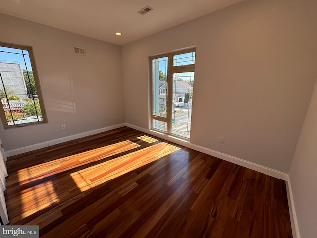 empty room with hardwood / wood-style floors