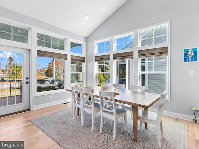 sunroom / solarium featuring a healthy amount of sunlight and vaulted ceiling