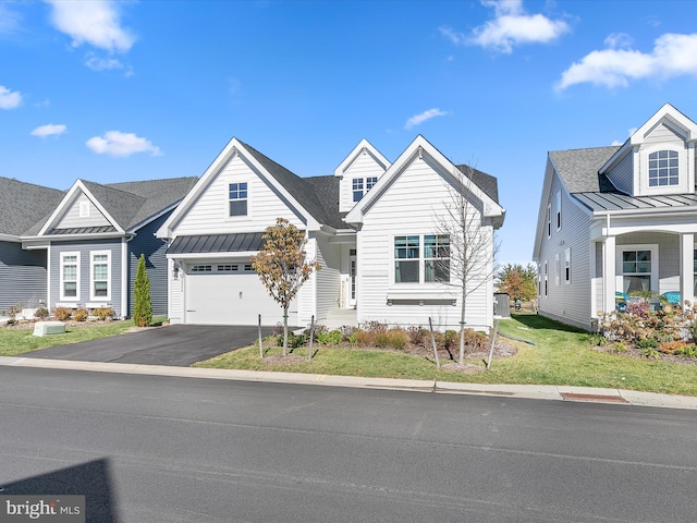 view of front of house with a front yard and a garage