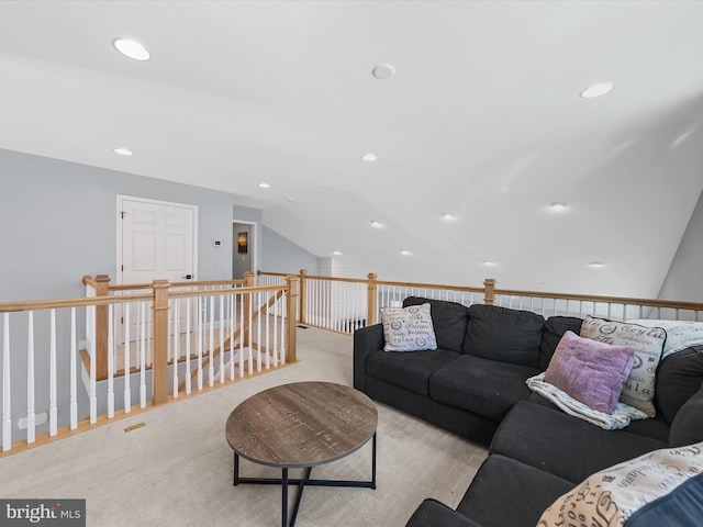 carpeted living room featuring vaulted ceiling