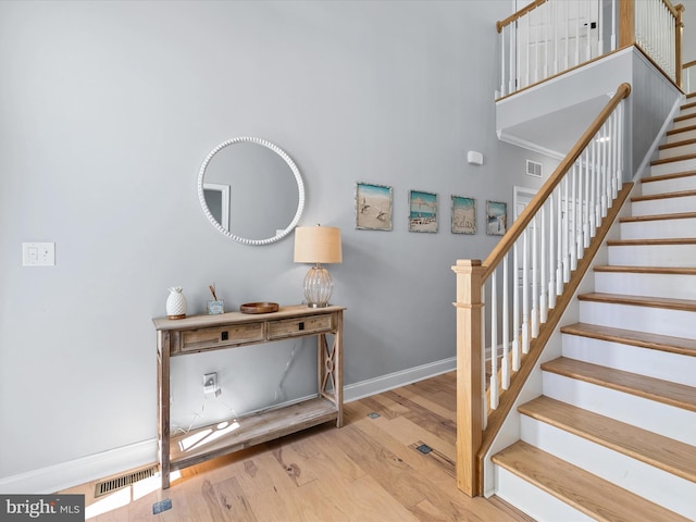 30579 Canary Way Unit 5, Ocean View, DE 19970 - stairs featuring wood finished floors, baseboards, and a towering ceiling