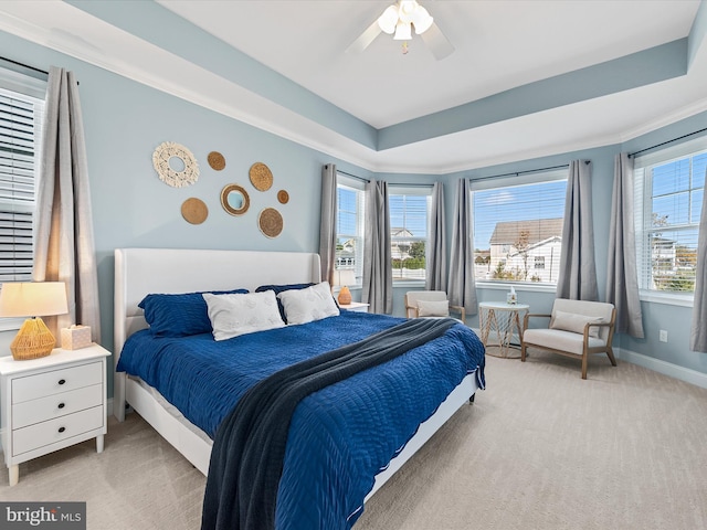 carpeted bedroom featuring multiple windows, crown molding, and ceiling fan