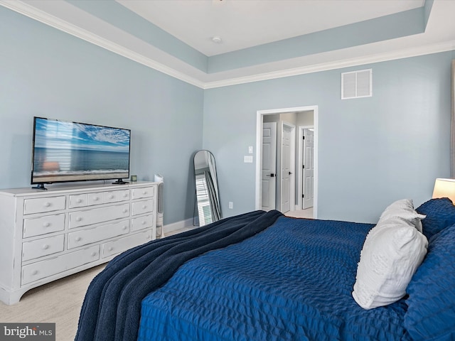 carpeted bedroom with crown molding and a raised ceiling