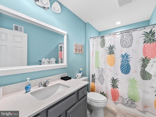 bathroom with toilet, vanity, and a shower with shower curtain