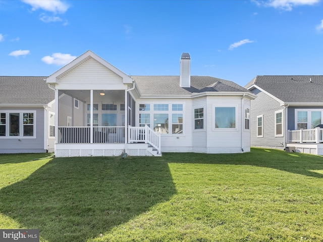 30579 Canary Way Unit 5, Ocean View, DE 19970 - rear view of property with a chimney, a yard, a sunroom, and a shingled roof