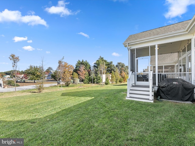 view of yard with a sunroom and ceiling fan