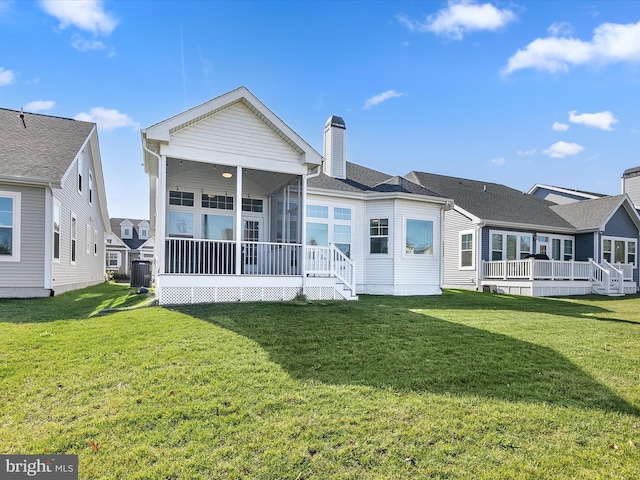 30579 Canary Way Unit 5, Ocean View, DE 19970 - rear view of property featuring a sunroom, a chimney, a lawn, and central air condition unit