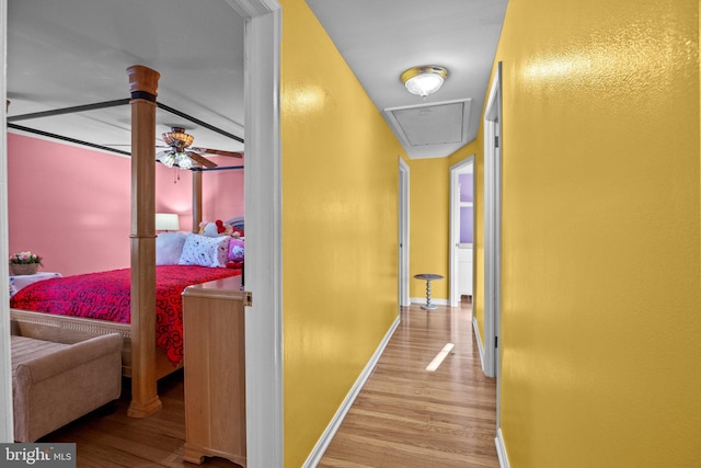 corridor with light hardwood / wood-style floors