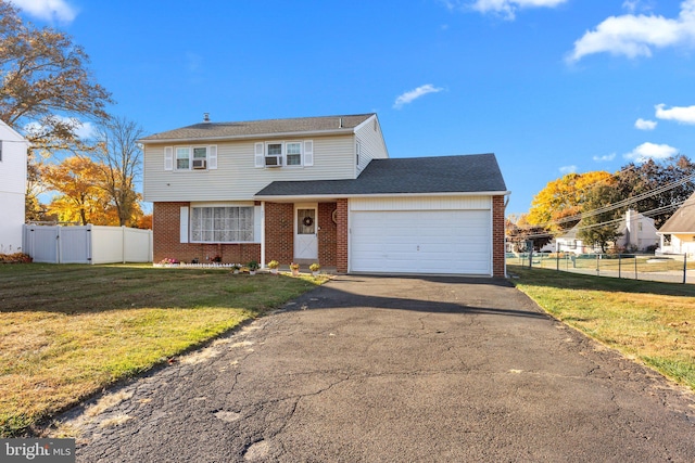 view of property with a front lawn and a garage