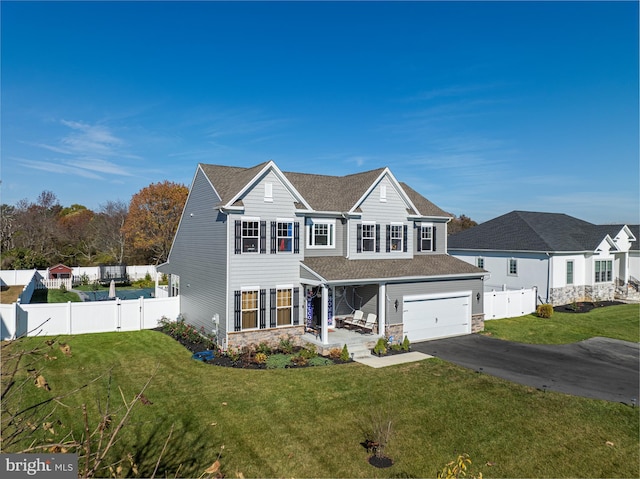 view of front of house featuring a front yard and a garage