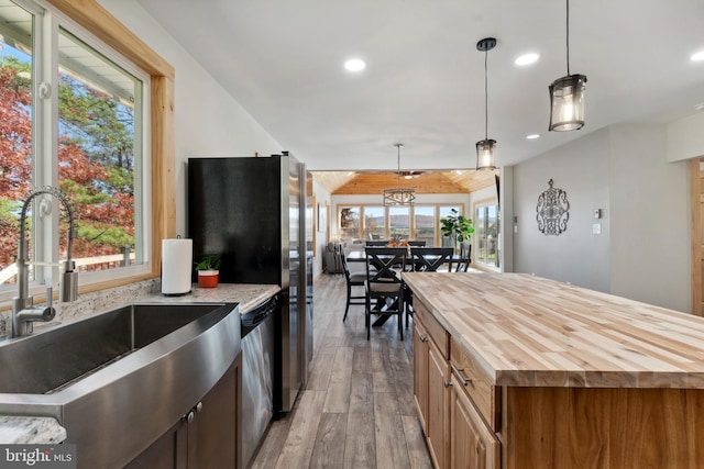 kitchen featuring pendant lighting, light hardwood / wood-style flooring, and a healthy amount of sunlight