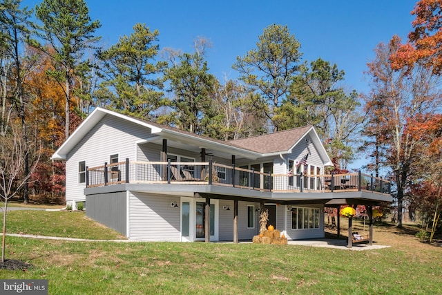 rear view of house with a wooden deck, ceiling fan, a patio, and a yard