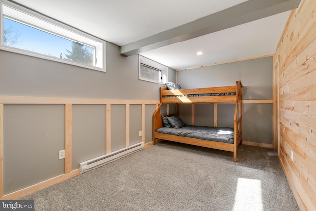 unfurnished bedroom with a baseboard heating unit and carpet