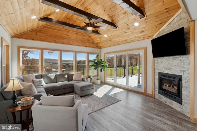 living room with wood ceiling, hardwood / wood-style flooring, high vaulted ceiling, beamed ceiling, and a fireplace