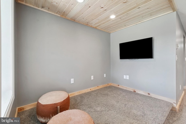 living area with carpet and wood ceiling