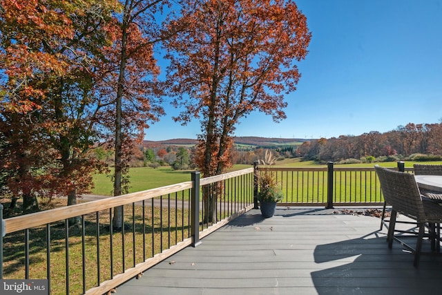 deck with a lawn and a mountain view