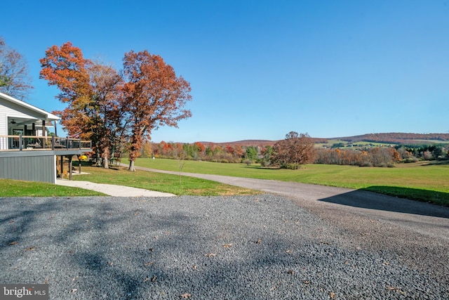 view of yard featuring a deck with mountain view