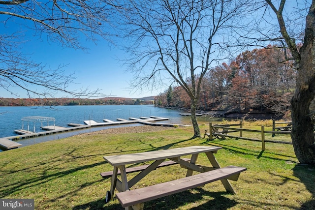 exterior space featuring a water view and a lawn