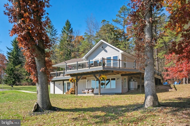 view of property with a front lawn and a wooden deck