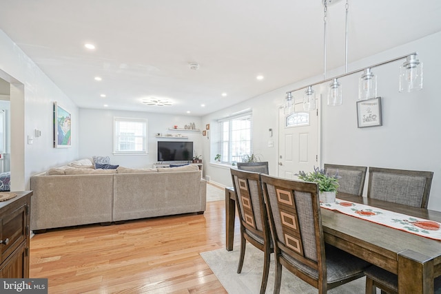 dining area with light hardwood / wood-style flooring and plenty of natural light