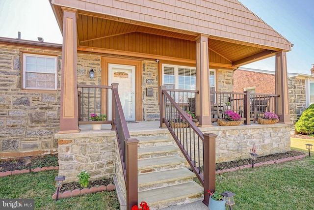 view of exterior entry with covered porch